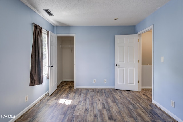 152 Gray Station Rd Unit 35, Gray, TN 37615 - unfurnished bedroom with a textured ceiling, wood finished floors, and a walk in closet
