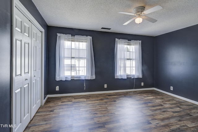 152 Gray Station Rd Unit 35, Gray, TN 37615 - unfurnished bedroom with a textured ceiling, dark wood finished floors, a closet, and ceiling fan