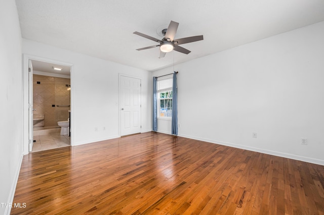 216 Mockingbird Pl, Jonesborough, TN 37659 - unfurnished bedroom featuring wood finished floors, ensuite bathroom, and ceiling fan