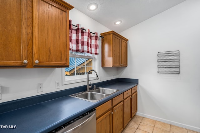 216 Mockingbird Pl, Jonesborough, TN 37659 - kitchen with dark countertops, light tile patterned floors, brown cabinets, stainless steel dishwasher, and recessed lighting