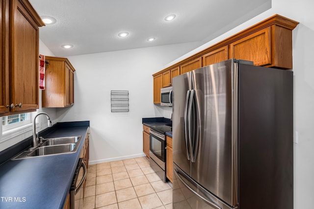 216 Mockingbird Pl, Jonesborough, TN 37659 - kitchen featuring stainless steel appliances, dark countertops, brown cabinetry, recessed lighting, and light tile patterned floors
