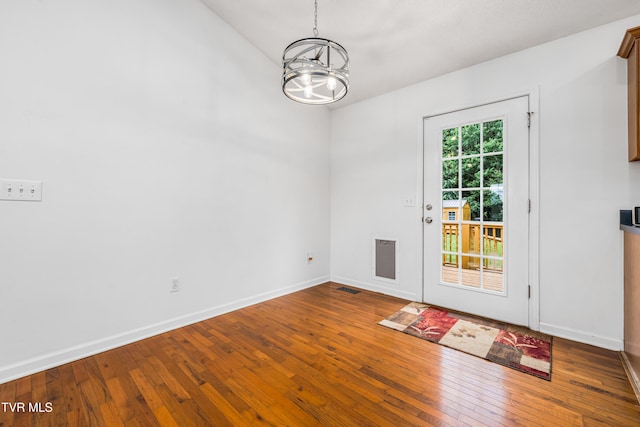 216 Mockingbird Pl, Jonesborough, TN 37659 - unfurnished dining area featuring a chandelier, hardwood / wood-style floors, and vaulted ceiling