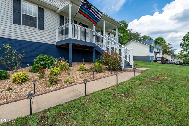 216 Mockingbird Pl, Jonesborough, TN 37659 - view of property exterior featuring a yard, stairway, covered porch, and brick siding