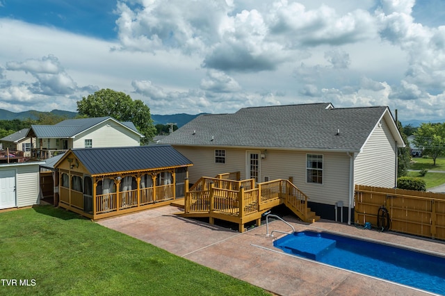 216 Mockingbird Pl, Jonesborough, TN 37659 - back of property featuring a deck with mountain view, a sunroom, a patio, and roof with shingles
