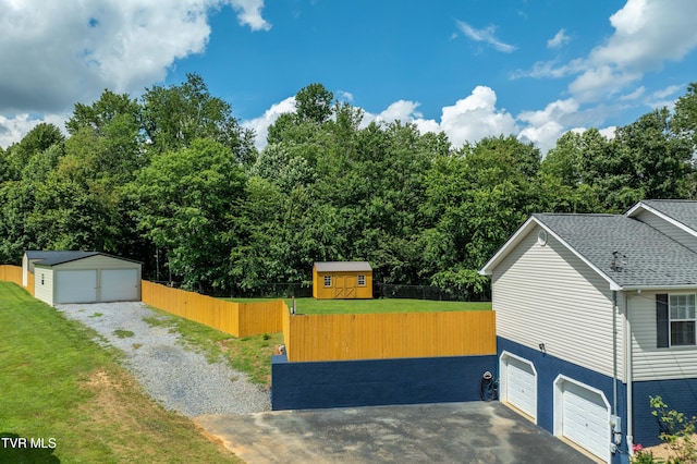216 Mockingbird Pl, Jonesborough, TN 37659 - view of front of property with gravel driveway, an outdoor structure, an attached garage, and roof with shingles