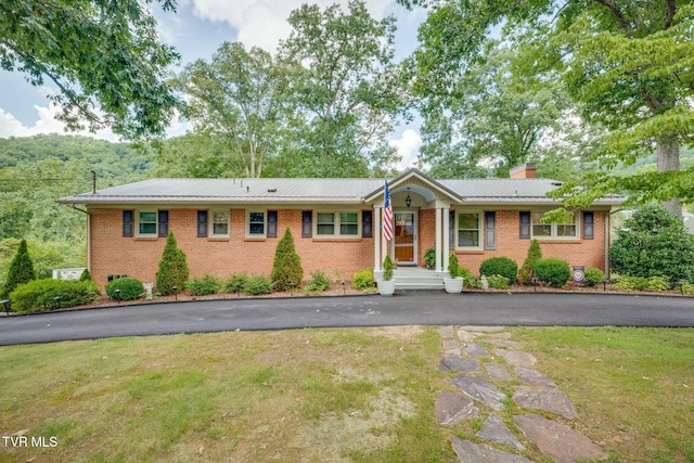 312 Timberlane Rd, Bristol, TN 37620 - single story home with brick siding, a chimney, a front yard, and a metal roof