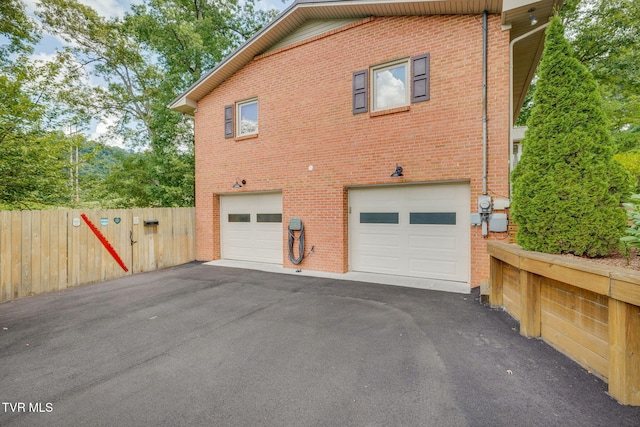 312 Timberlane Rd, Bristol, TN 37620 - view of side of home featuring a garage, driveway, and brick siding