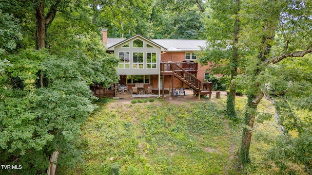 312 Timberlane Rd, Bristol, TN 37620 - rear view of property featuring stairway, a patio area, a wooden deck, a chimney, and brick siding