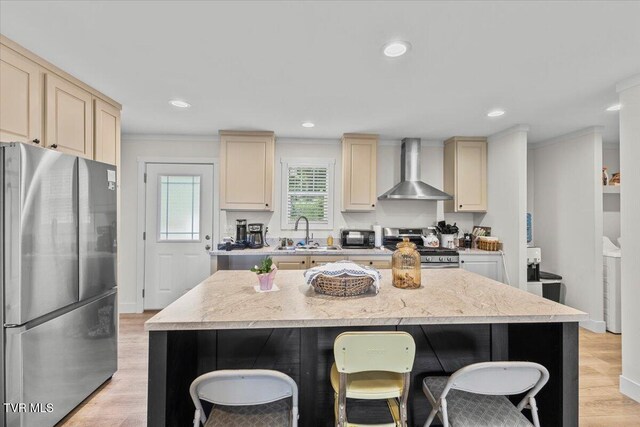 145 Oakwood Dr Way, Newport, TN 37821 - kitchen featuring stainless steel appliances, wall chimney range hood, cream cabinetry, a breakfast bar, and recessed lighting