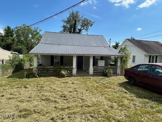 938 Barker St, Bristol, TN 37620 - view of front of property featuring covered porch, a metal roof, and a front lawn