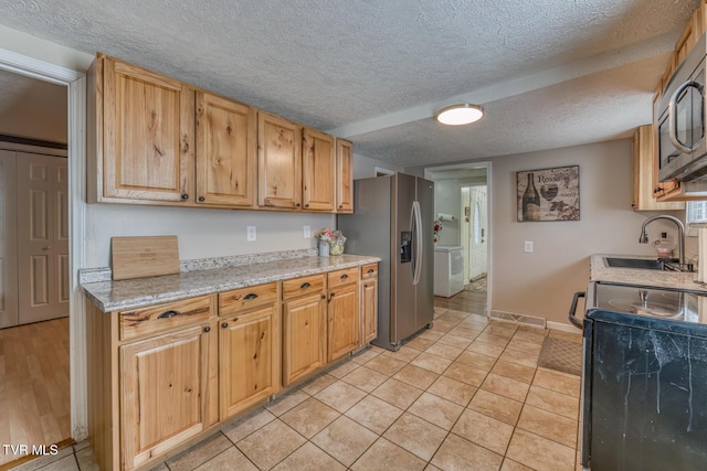 218 Kirkwood St, Glade Spring, VA 24340 - kitchen with appliances with stainless steel finishes, a textured ceiling, and light tile patterned floors
