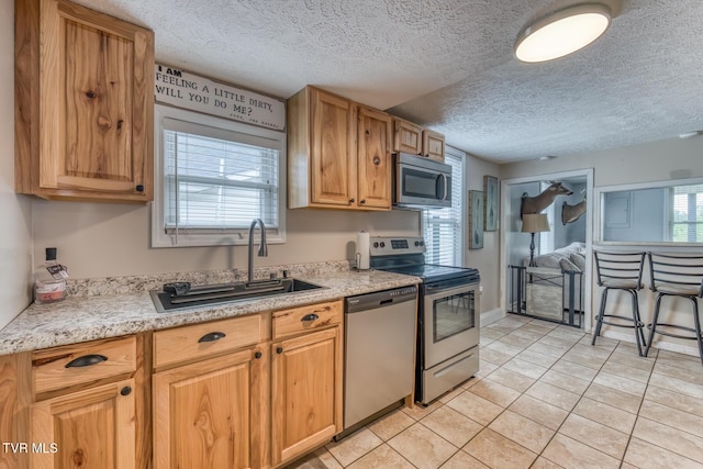 218 Kirkwood St, Glade Spring, VA 24340 - kitchen featuring stainless steel appliances, light countertops, a textured ceiling, and light tile patterned floors