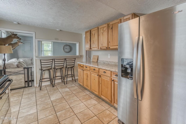 218 Kirkwood St, Glade Spring, VA 24340 - kitchen featuring stainless steel refrigerator with ice dispenser, a textured ceiling, light tile patterned floors, stove, and open floor plan