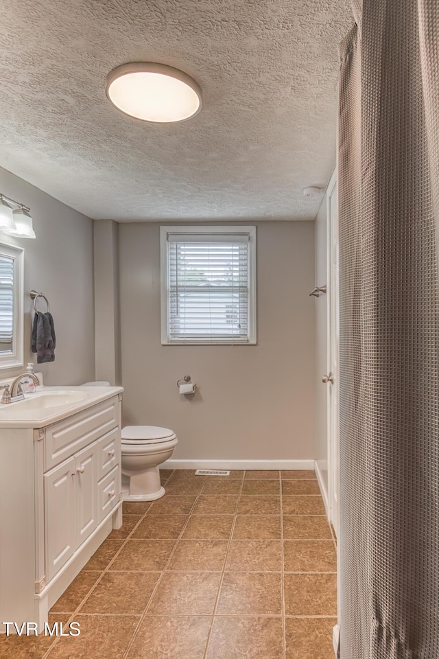 218 Kirkwood St, Glade Spring, VA 24340 - bathroom featuring vanity, tile patterned flooring, a textured ceiling, and curtained shower