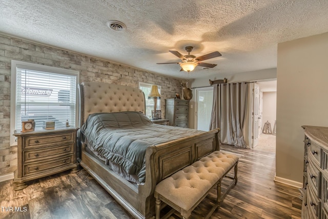 218 Kirkwood St, Glade Spring, VA 24340 - bedroom with dark wood-style flooring, a textured ceiling, and a ceiling fan