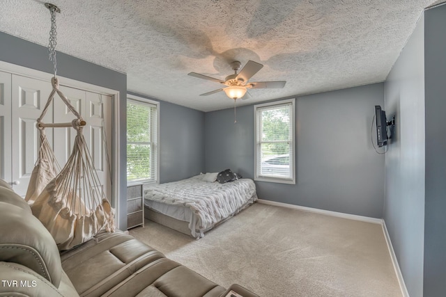 218 Kirkwood St, Glade Spring, VA 24340 - carpeted bedroom featuring multiple windows, ceiling fan, and a textured ceiling