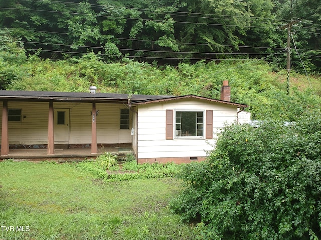 362 Rakes Ridge Rd, Birchleaf, VA 24220 - view of side of property featuring covered porch, a chimney, crawl space, and a yard