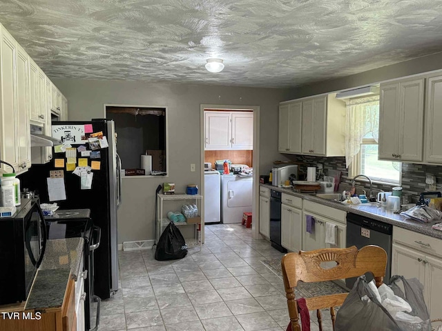 2818 Dungannon Rd, Coeburn, VA 24230 - kitchen featuring independent washer and dryer, black electric range, tasteful backsplash, dishwasher, and range hood