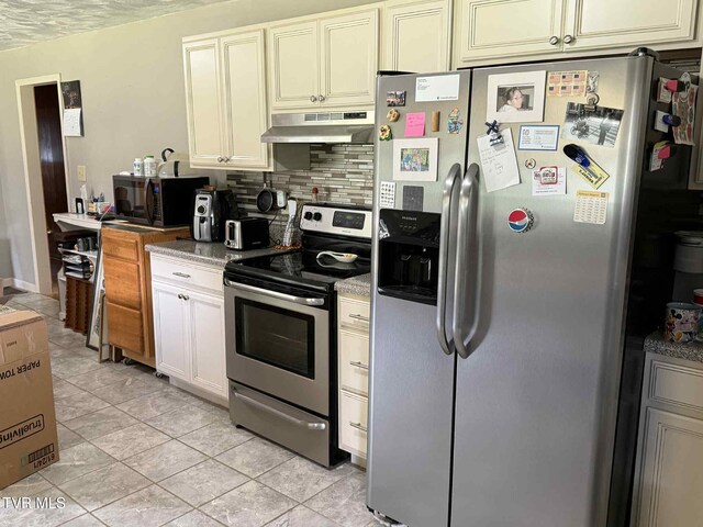 2818 Dungannon Rd, Coeburn, VA 24230 - kitchen featuring appliances with stainless steel finishes, under cabinet range hood, decorative backsplash, and light tile patterned floors