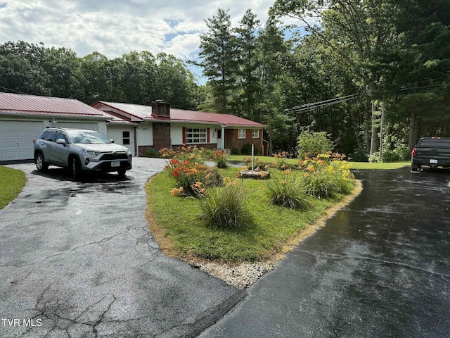 2818 Dungannon Rd, Coeburn, VA 24230 - ranch-style home with driveway, an attached garage, a metal roof, and a chimney