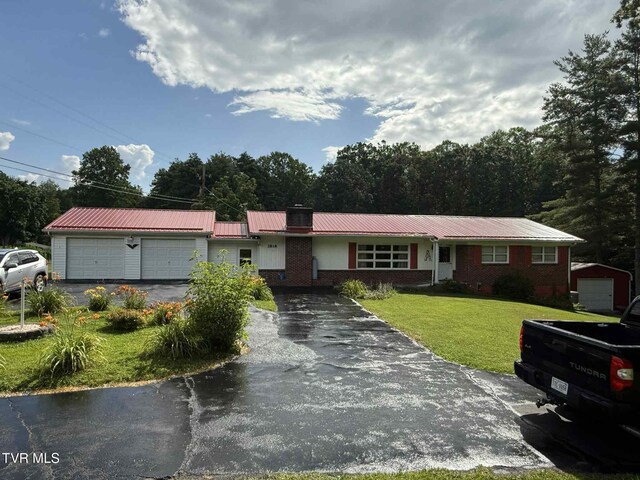 2818 Dungannon Rd, Coeburn, VA 24230 - ranch-style home with a garage, brick siding, a front lawn, driveway, and a metal roof