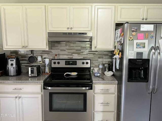 2818 Dungannon Rd, Coeburn, VA 24230 - kitchen with stainless steel appliances, under cabinet range hood, tasteful backsplash, and white cabinetry