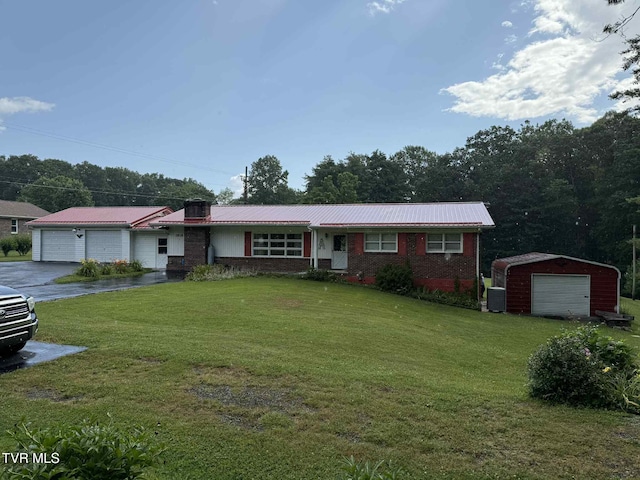 2818 Dungannon Rd, Coeburn, VA 24230 - ranch-style house featuring a front lawn, brick siding, a metal roof, and an outbuilding
