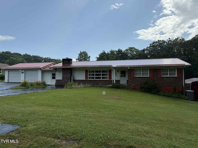 2818 Dungannon Rd, Coeburn, VA 24230 - ranch-style house featuring an attached garage, driveway, a metal roof, a front lawn, and a chimney
