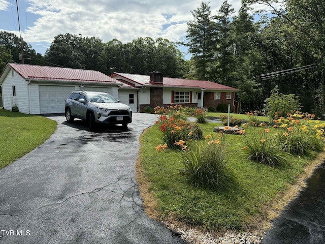 2818 Dungannon Rd, Coeburn, VA 24230 - single story home with asphalt driveway, a garage, a metal roof, a front yard, and a chimney