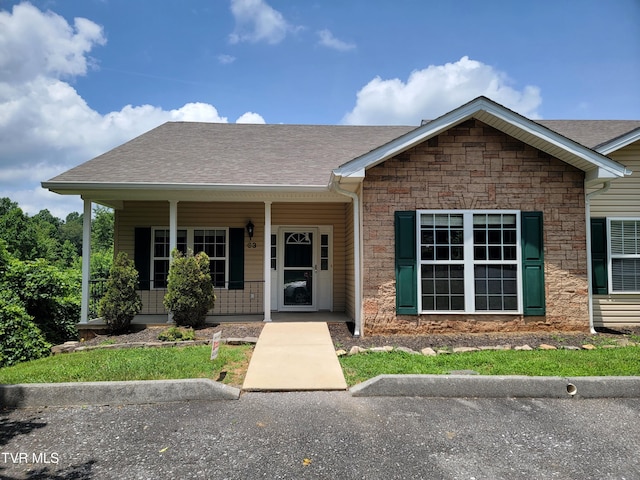 63 Whisper Bnd Unit 1, Johnson City, TN 37604 - ranch-style house with a porch, stone siding, and roof with shingles