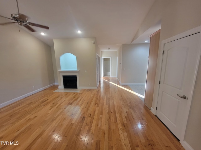 63 Whisper Bnd Unit 1, Johnson City, TN 37604 - unfurnished living room featuring ceiling fan, light wood finished floors, a fireplace with flush hearth, and lofted ceiling