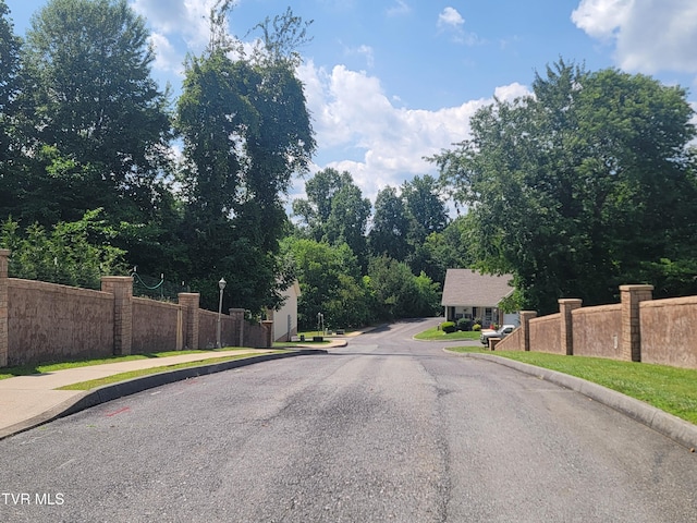 63 Whisper Bnd Unit 1, Johnson City, TN 37604 - view of asphalt street with street lighting, curbs, and sidewalks