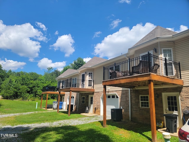 63 Whisper Bnd Unit 1, Johnson City, TN 37604 - back of property featuring a yard, a deck, and an attached garage