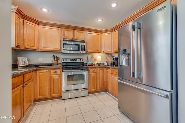 417 Piper Gln, Gray, TN 37615 - kitchen featuring appliances with stainless steel finishes, light tile patterned floors, recessed lighting, dark stone counters, and brown cabinetry