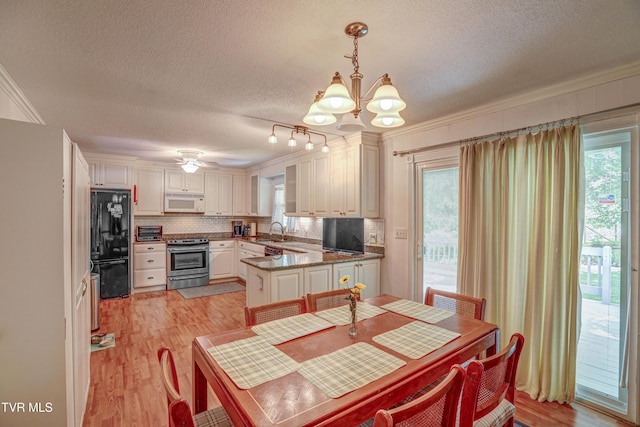 107 Dover Ln, Bristol, TN 37620 - dining space featuring a chandelier, a textured ceiling, healthy amount of natural light, ornamental molding, and light wood finished floors