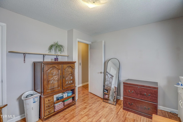 107 Dover Ln, Bristol, TN 37620 - bedroom with light wood finished floors and a textured ceiling