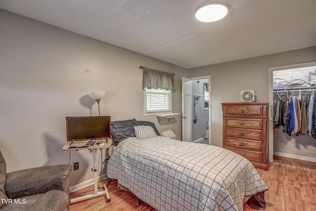 107 Dover Ln, Bristol, TN 37620 - bedroom featuring light wood-type flooring, a spacious closet, and connected bathroom