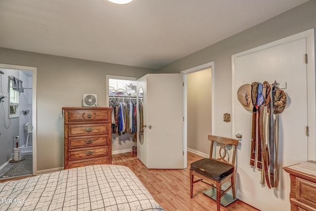107 Dover Ln, Bristol, TN 37620 - bedroom with light wood-style flooring, a spacious closet, and ensuite bath