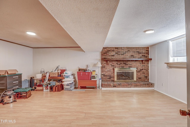 107 Dover Ln, Bristol, TN 37620 - below grade area featuring wood finished floors, a textured ceiling, and a brick fireplace