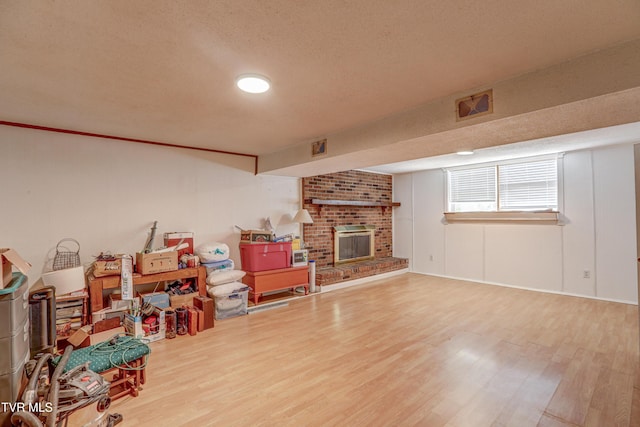107 Dover Ln, Bristol, TN 37620 - living area with wood finished floors, a brick fireplace, and a textured ceiling