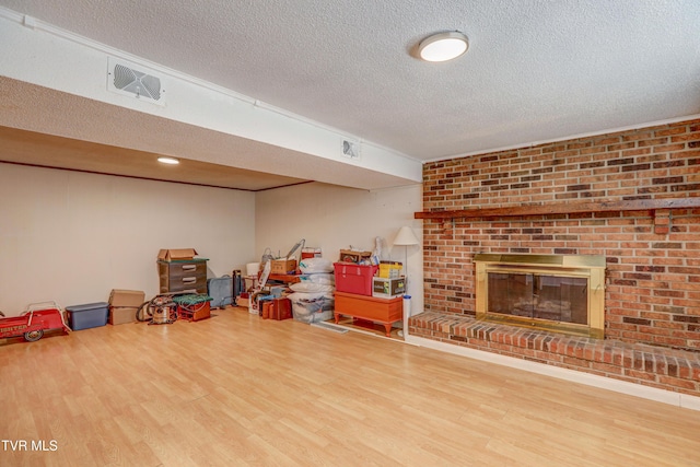 107 Dover Ln, Bristol, TN 37620 - finished below grade area with wood finished floors, a textured ceiling, and a brick fireplace