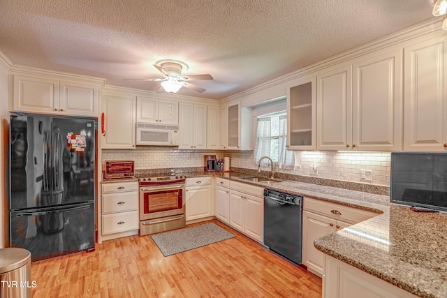 107 Dover Ln, Bristol, TN 37620 - kitchen featuring black appliances, light wood-type flooring, tasteful backsplash, a ceiling fan, and light stone counters