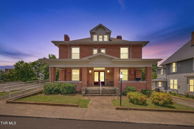 522 Alabama St, Bristol, TN 37620 - american foursquare style home with a porch, a chimney, and brick siding