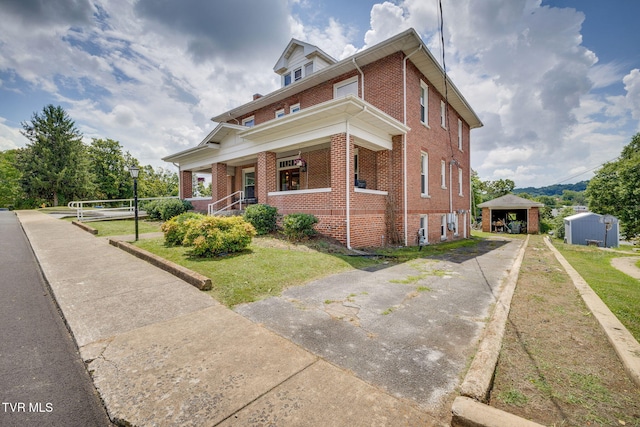 522 Alabama St, Bristol, TN 37620 - view of front of house featuring brick siding, a front yard, an outbuilding, and concrete driveway