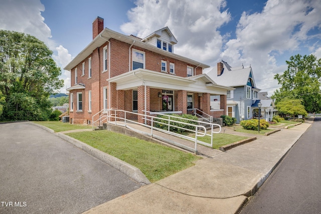 522 Alabama St, Bristol, TN 37620 - traditional style home featuring brick siding, covered porch, a chimney, and a front lawn