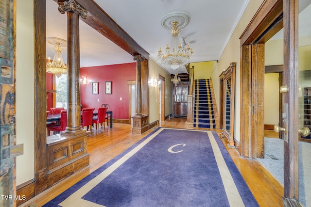 522 Alabama St, Bristol, TN 37620 - hallway with a chandelier, wood finished floors, and ornate columns