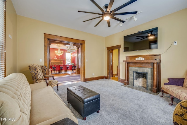 522 Alabama St, Bristol, TN 37620 - carpeted living room with a ceiling fan, a chandelier, and a fireplace