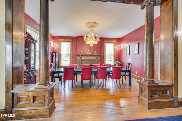 522 Alabama St, Bristol, TN 37620 - dining space with decorative columns, wood-type flooring, and a chandelier