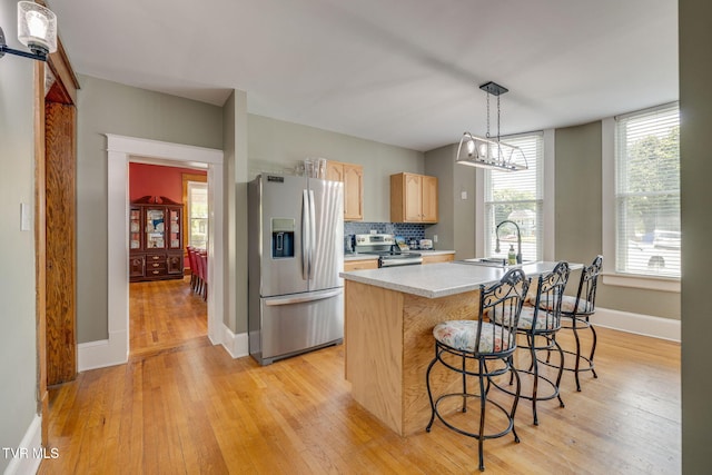 522 Alabama St, Bristol, TN 37620 - kitchen with appliances with stainless steel finishes, light brown cabinets, light countertops, and light wood-style flooring