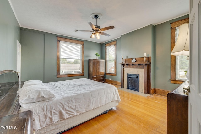 522 Alabama St, Bristol, TN 37620 - bedroom with a fireplace, wood finished floors, ornamental molding, and a ceiling fan